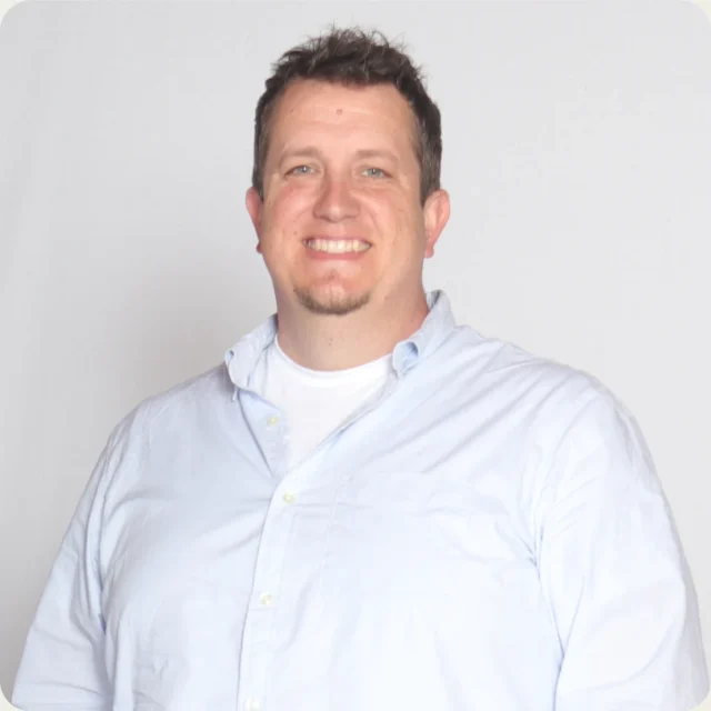 Dan Prout, Worship Pastor at Journey Church, smiling in a light blue button-down shirt.