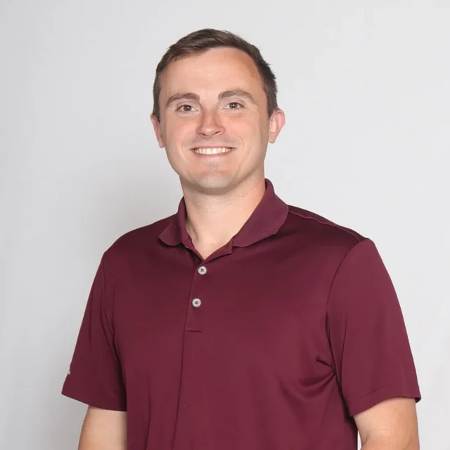 Zach Carmichael, Lead Pastor at Journey Church, smiling in a maroon polo shirt.